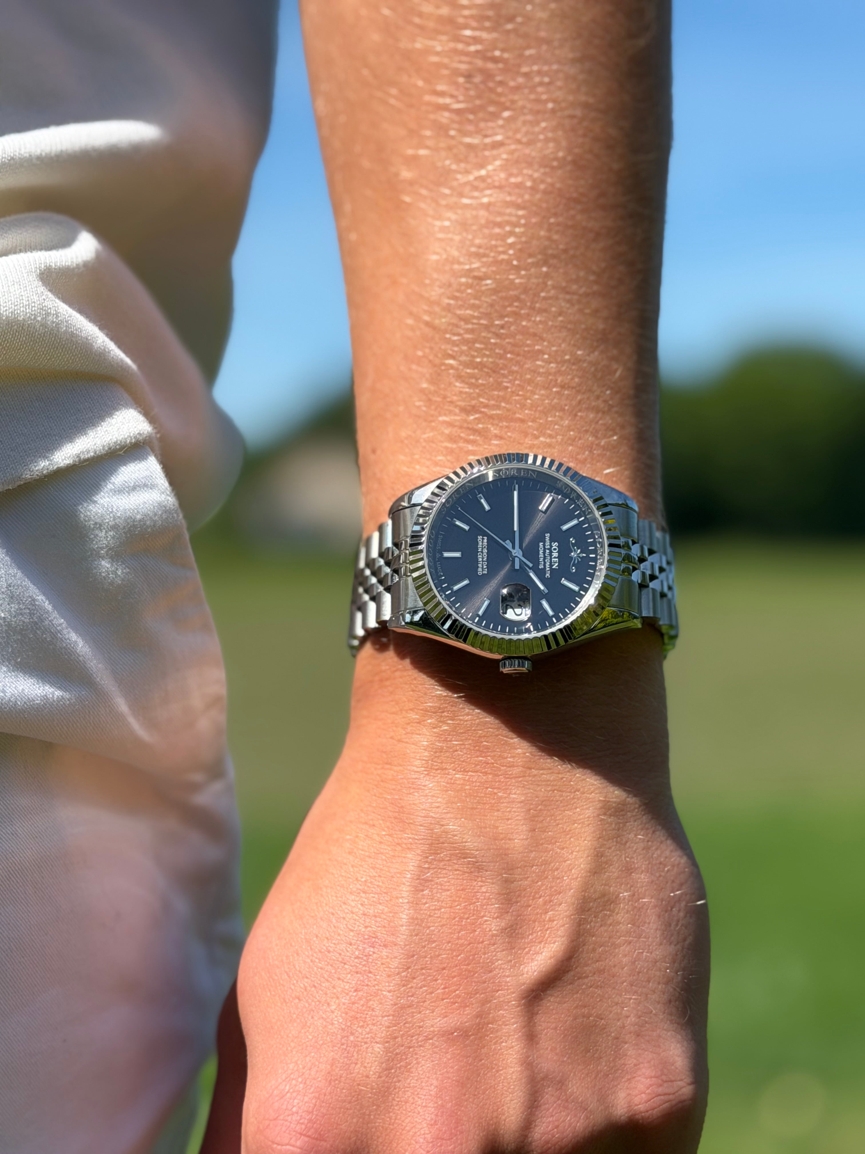 Soren Momentis Black watch on wrist — jubilee bracelet detail