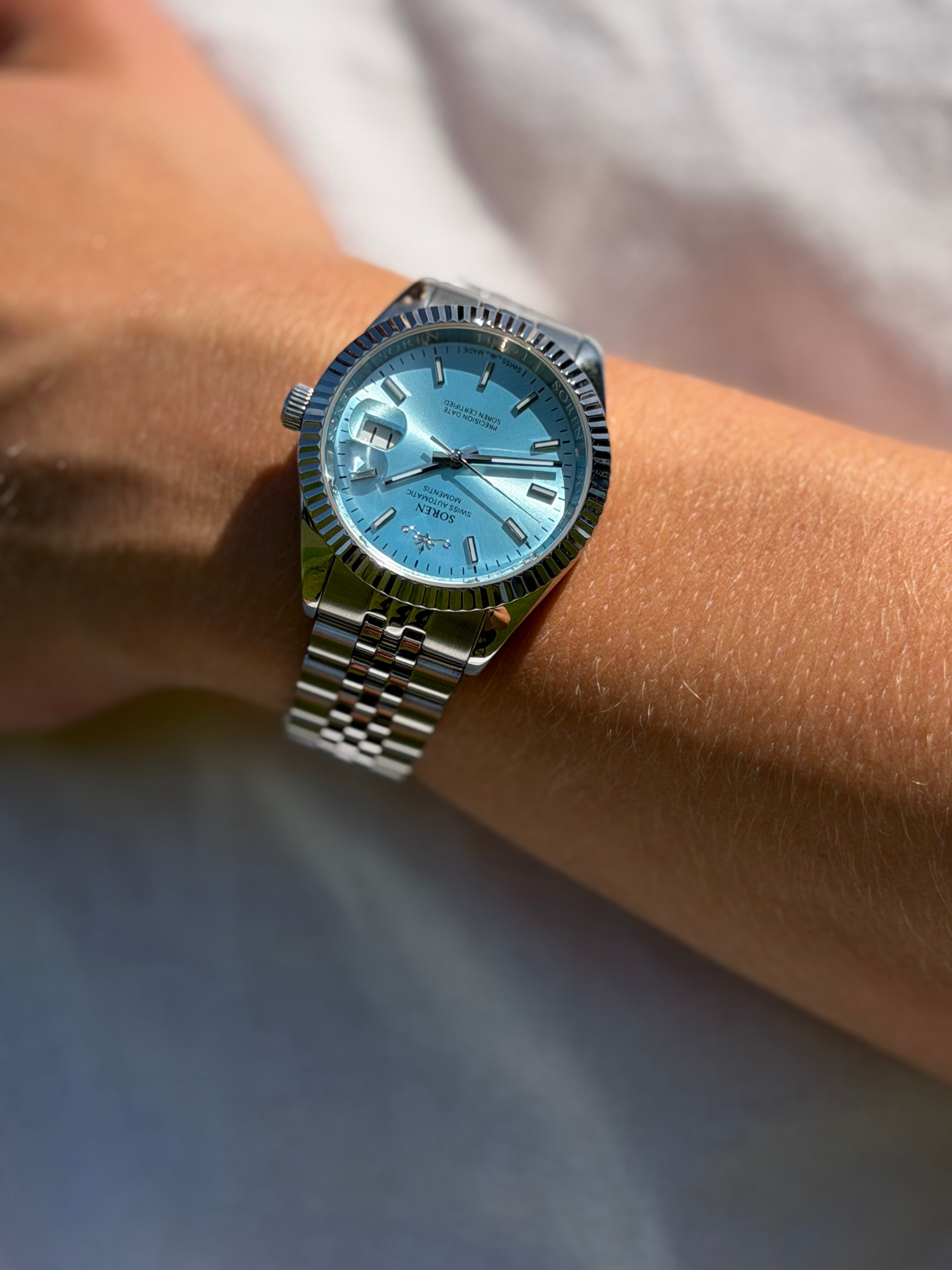 Soren Momentis Ice Blue wrist shot close-up — ice blue dial, jubilee bracelet