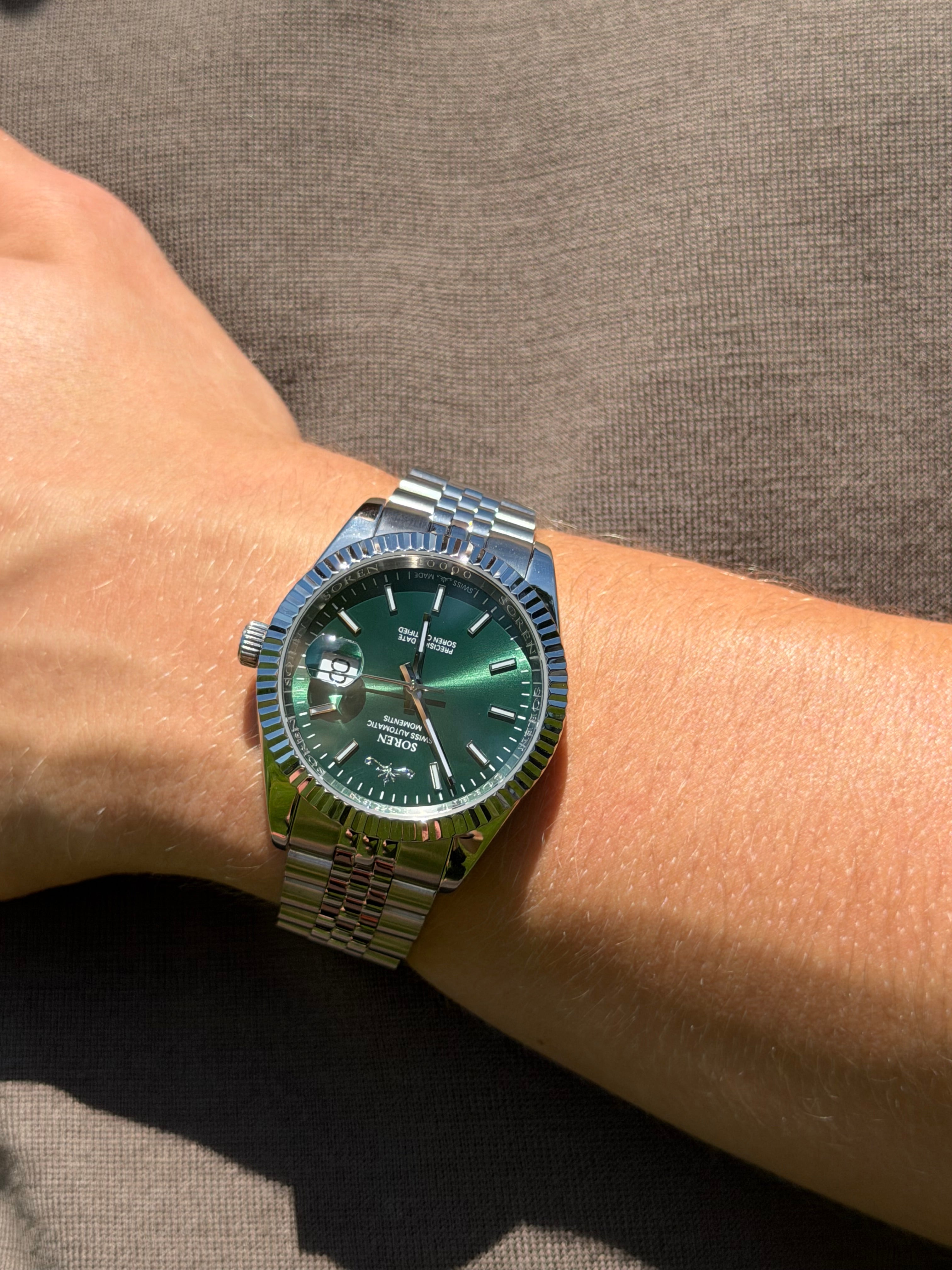Soren Momentis Green wrist shot close-up — Green dial, jubilee bracelet