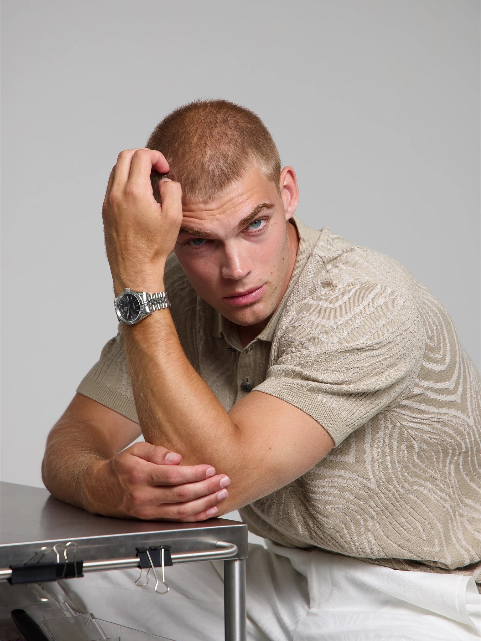 Model wearing a SOREN Momentis grey watch on a jubilee bracelet, seated