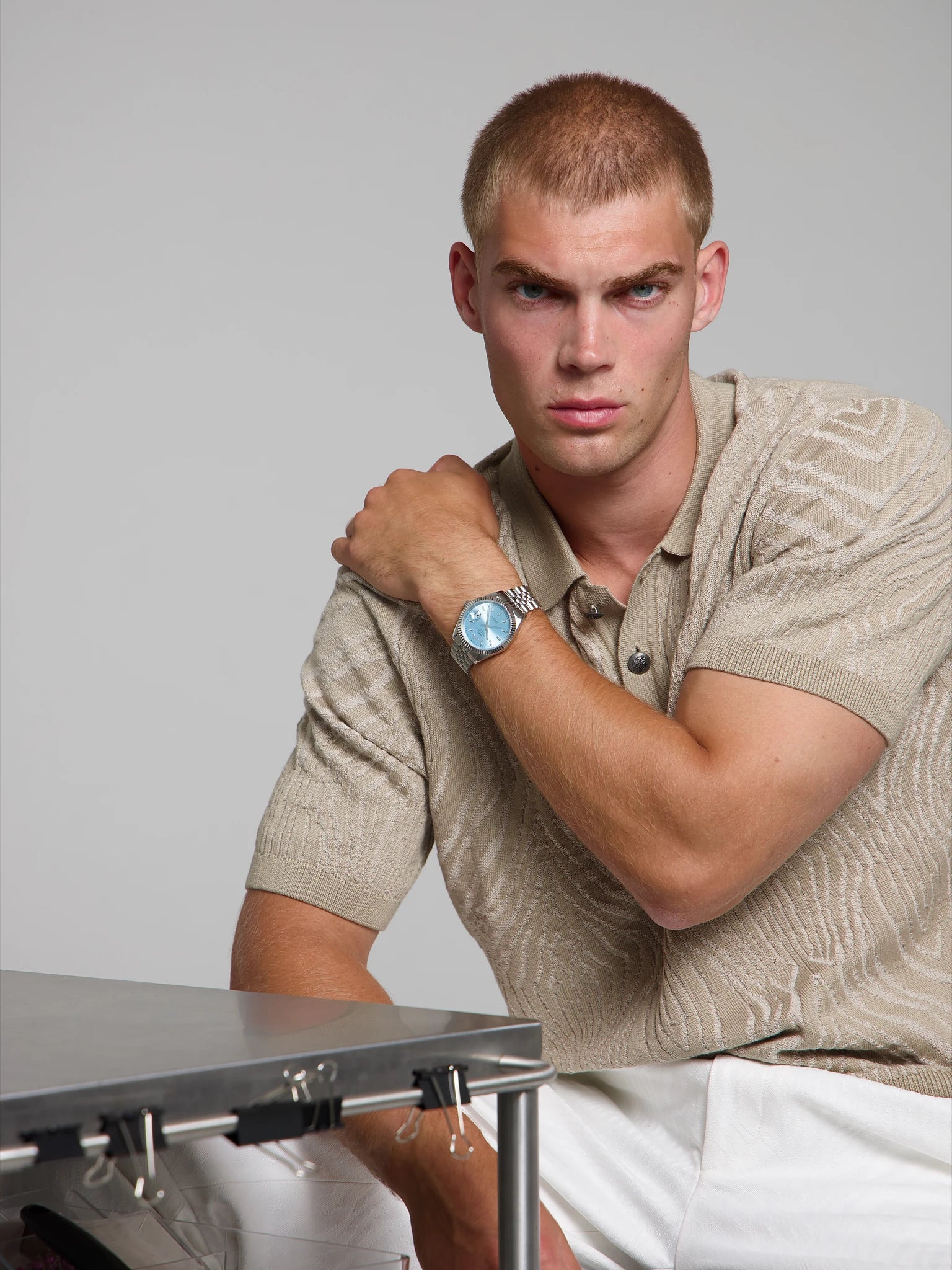 Model wearing a SOREN Momentis ice blue watch on a jubilee bracelet, seated