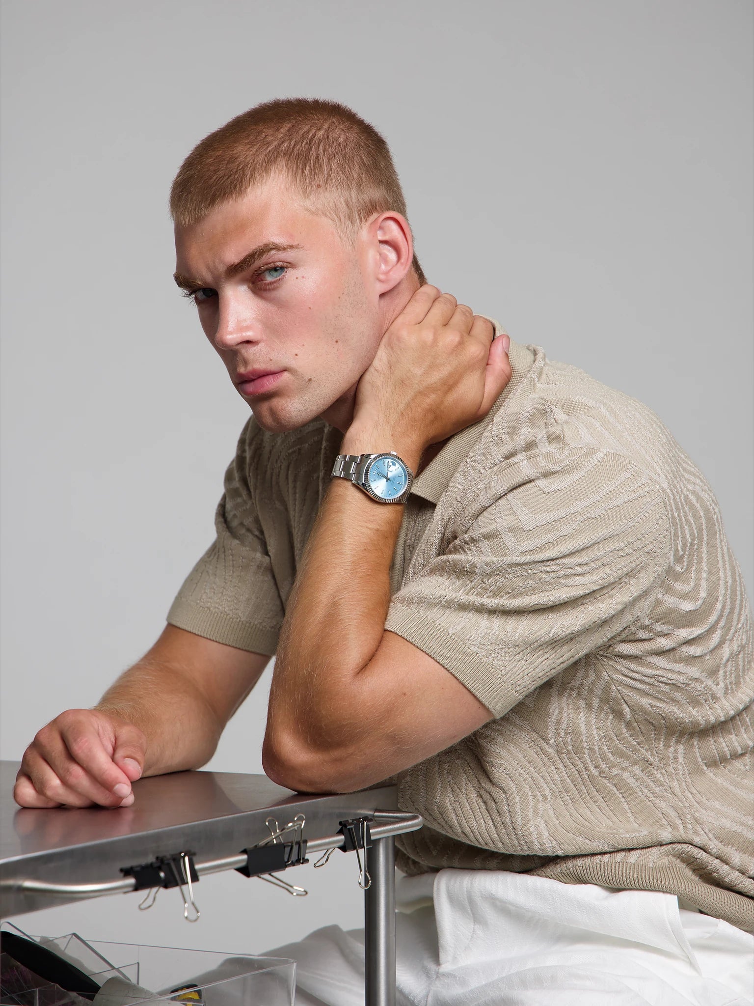 Model wearing a SOREN Momentis ice blue watch on a oyster bracelet, seated