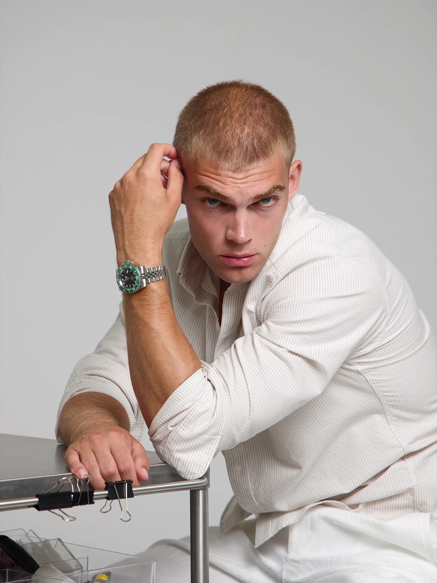Model wearing a SOREN oceanic green watch on a jubilee bracelet, seated