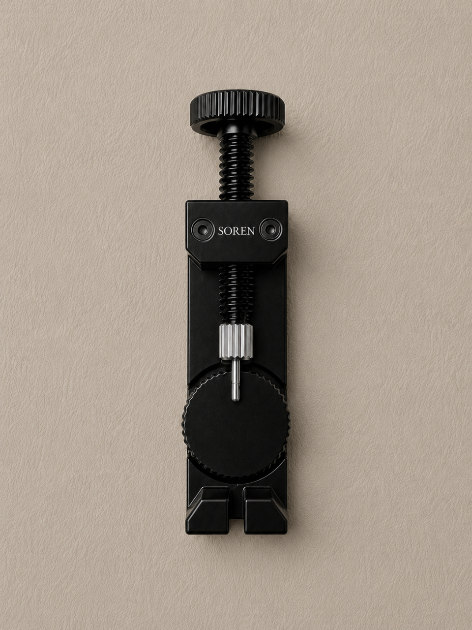 SOREN link adjustment tool in use — removing bracelet links from stainless steel watch
