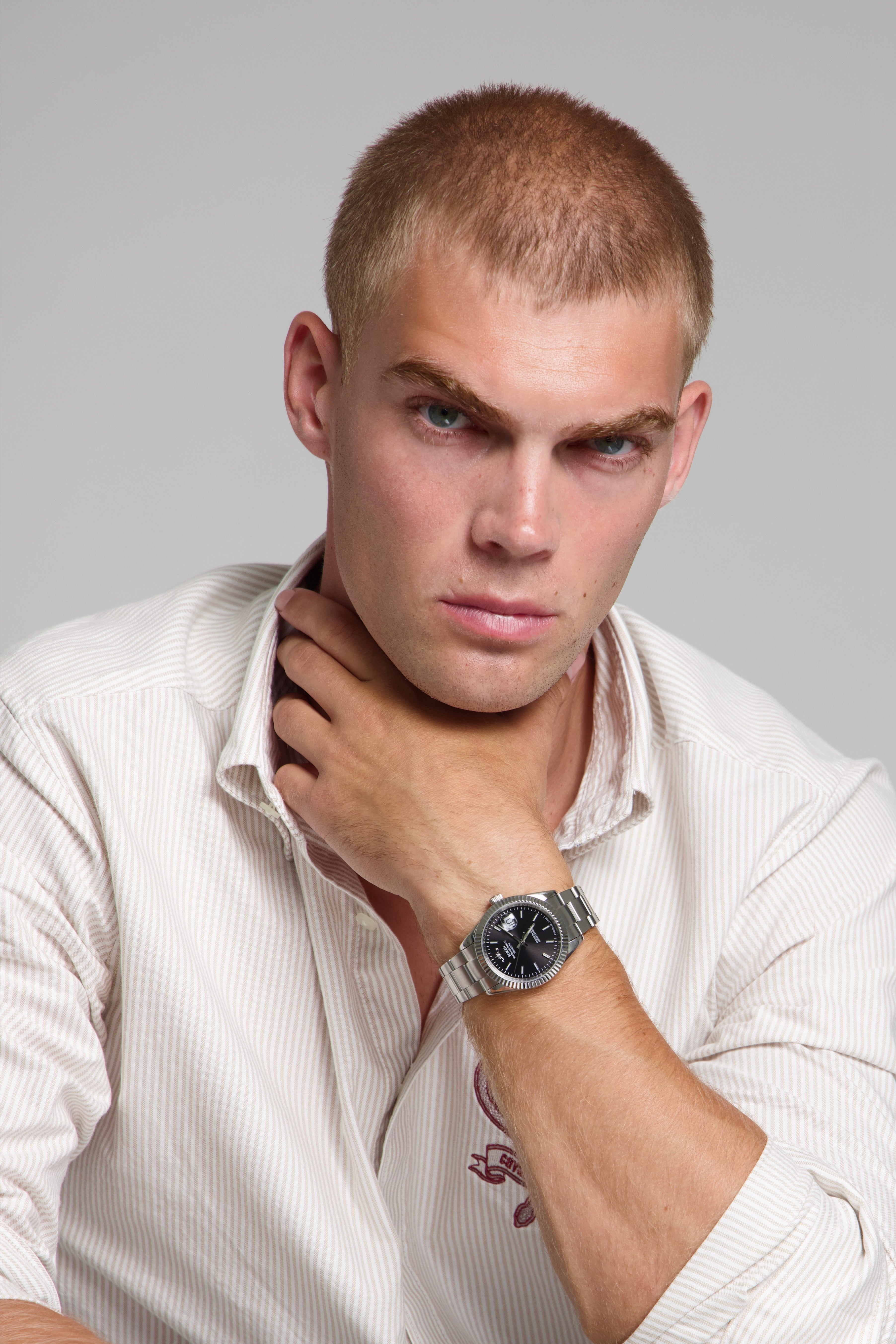 Model wearing a SOREN Momentis black watch on a oyster bracelet, seated
