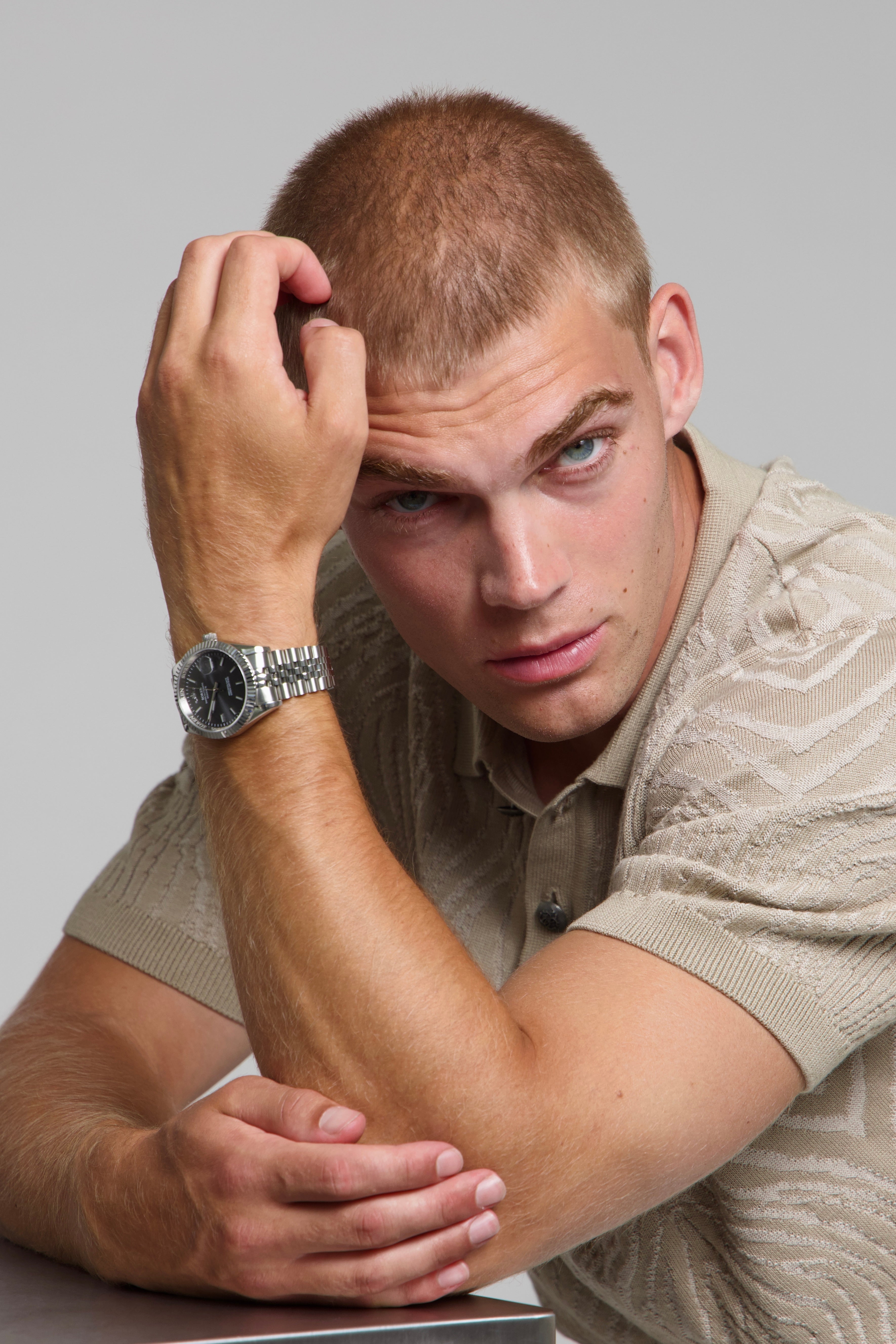 Model wearing a SOREN Momentis grey watch on a jubilee bracelet, seated
