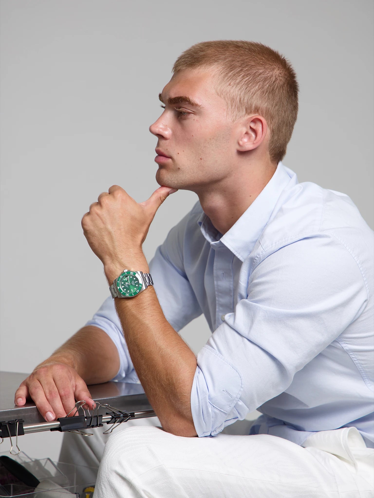 Model wearing a SOREN oceanic all green watch on a oyster bracelet, seated
