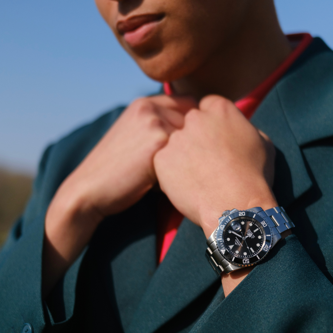 Man outdoors wearing a SOREN Oceanic black dive watch on a steel bracelet
